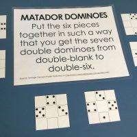 Matador Dominoes Puzzle Lying on Counter with Instructions.