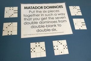 Matador Dominoes Puzzle Lying on Counter with Instructions.