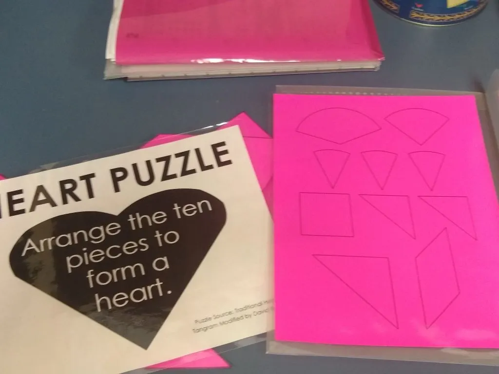laminated pages of printable heart tangram puzzle 