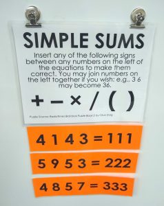 Simple Sums Puzzle Hanging on Dry Erase Board.