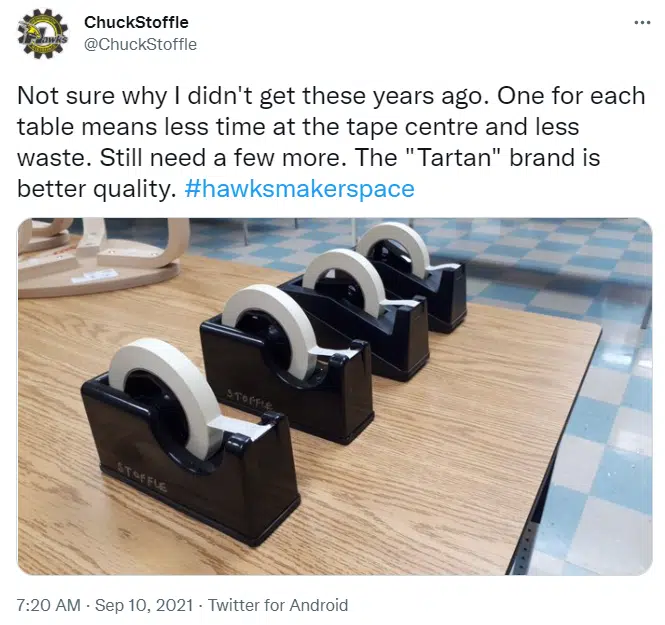 four tape dispensers holding masking tape on teacher desk in stem classroom 