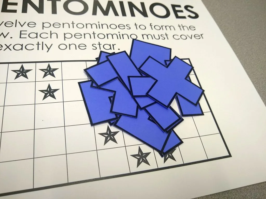 printed pentominoes pieces on blue paper 