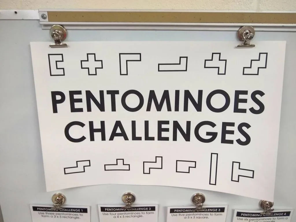 poster that reads pentominoes challenges with images of twelve different shapes of pentominoes 