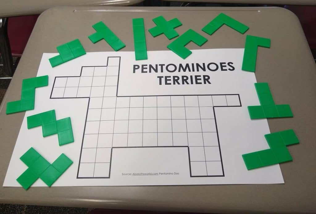 terrier shaped pentominoes animal puzzle with pentominoes laying around