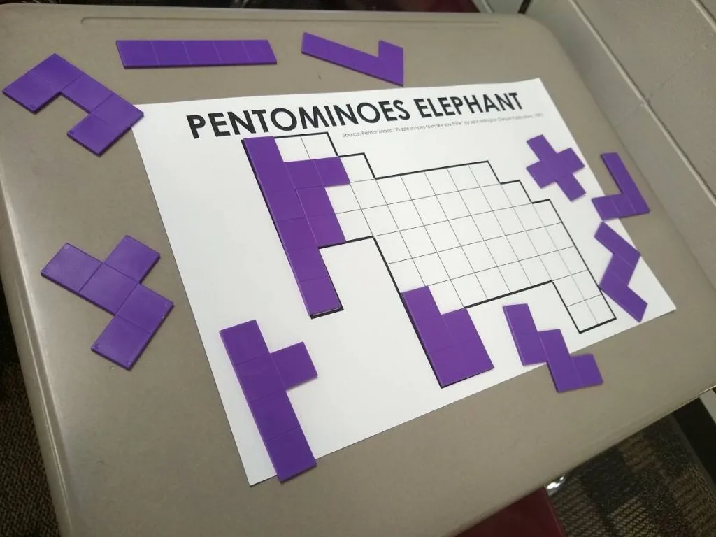 elephant pentominoes puzzle on student desk. 