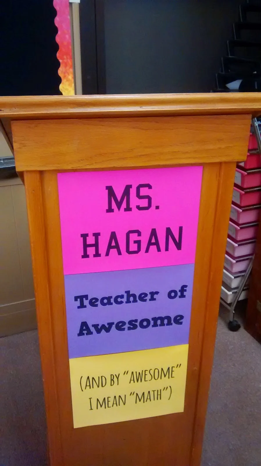 Teacher of awesome poster on podium