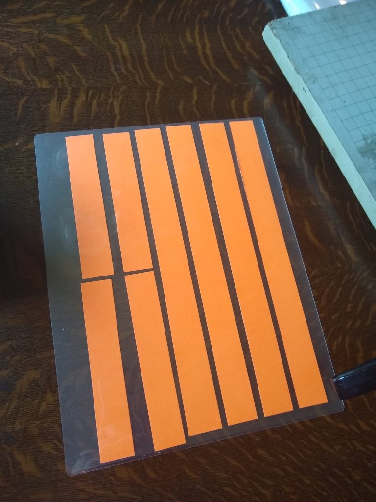 cardstock strips in laminating pouch. 