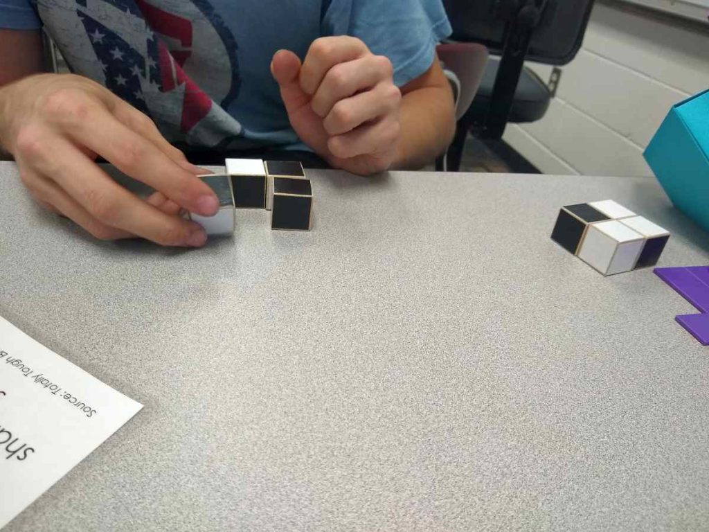 student working on chess cube puzzle 