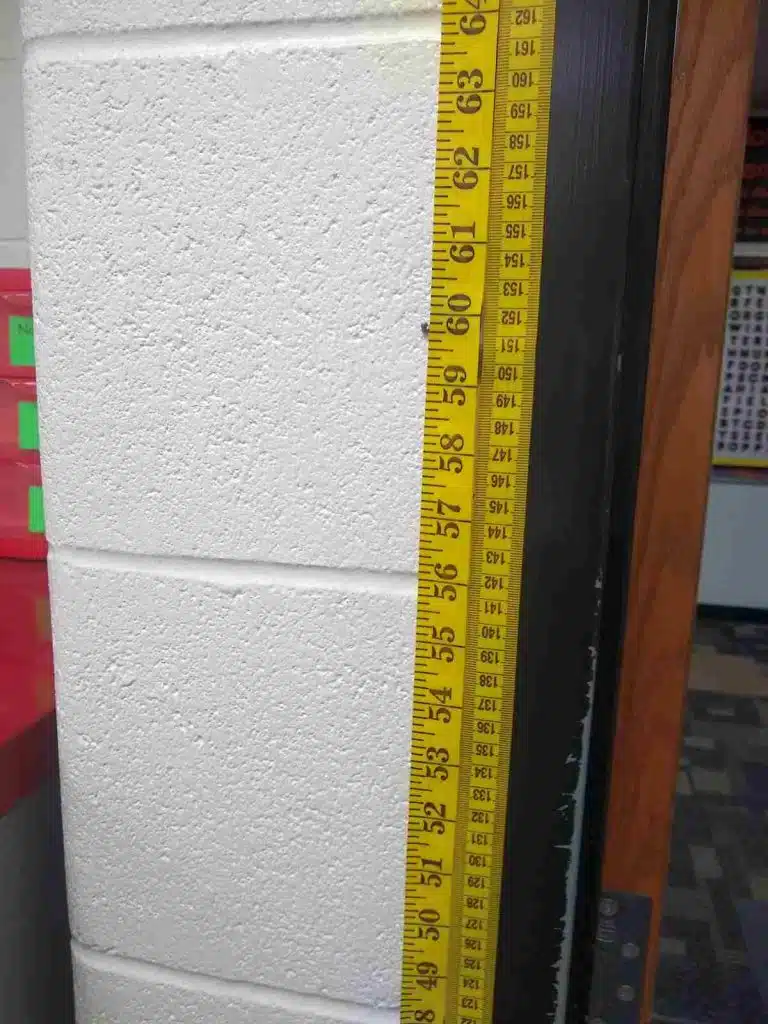 measuring tapes next to one another on wall 