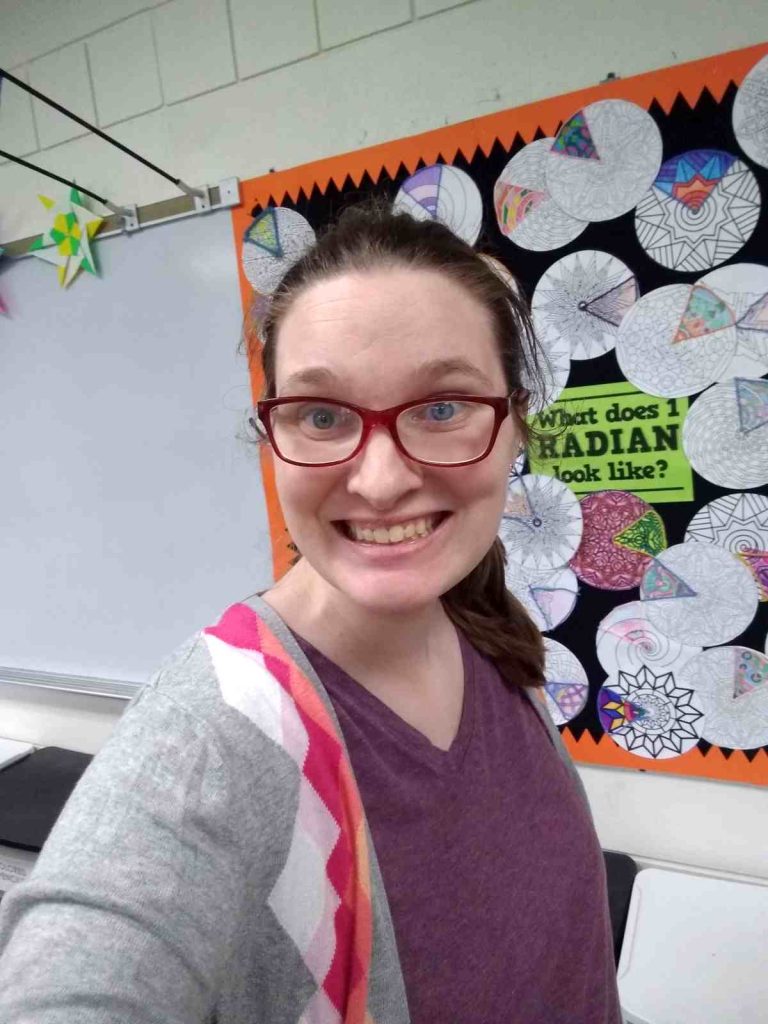 Sarah Carter standing in high school math classroom 