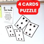4 playing cards puzzle hanging on dry erase board in math classroom