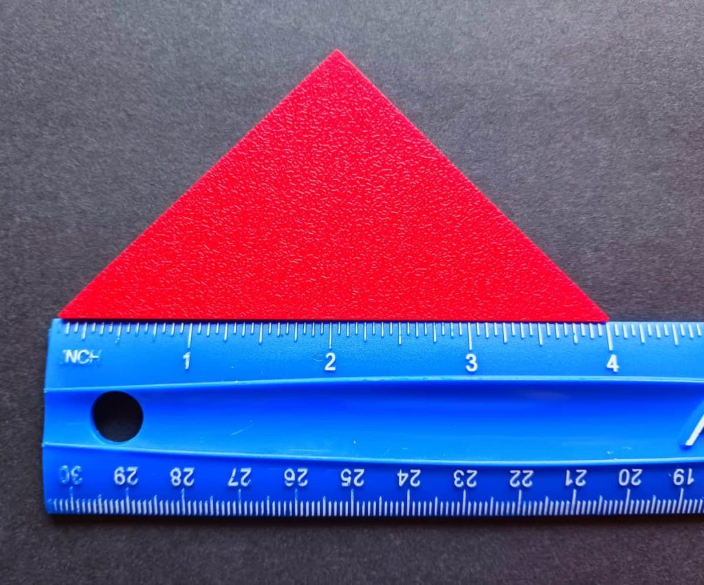 tangram triangle next to ruler 