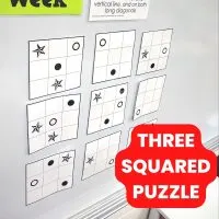 three squared puzzle hanging on dry erase board. 