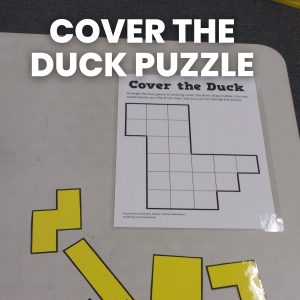 cover the duck puzzle laying on desk in high school math classroom 