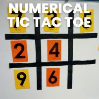 numerical tic tac toe game made of magnets on dry erase board in classroom 