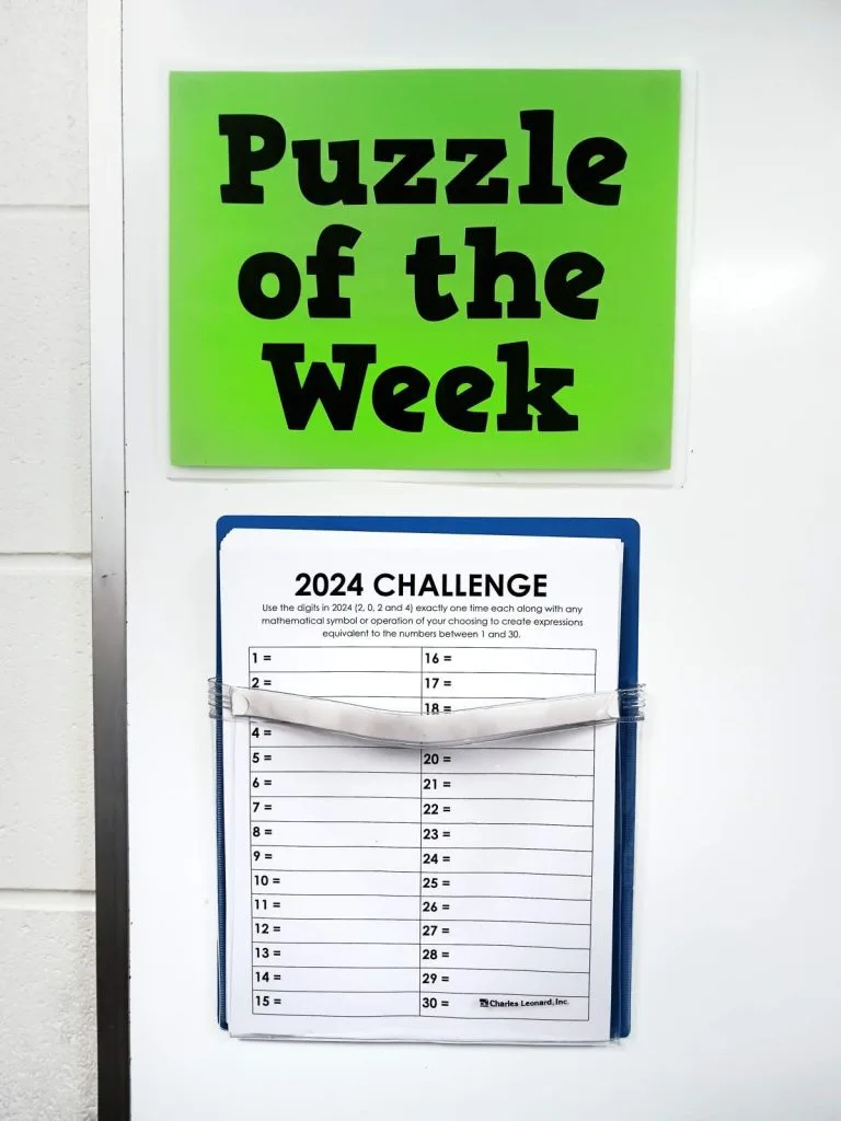 2024 yearly number challenge hanging in pocket under sign reading "puzzle of the week" 