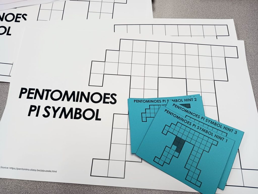 pentominoes pi symbol puzzle with blue hint cards