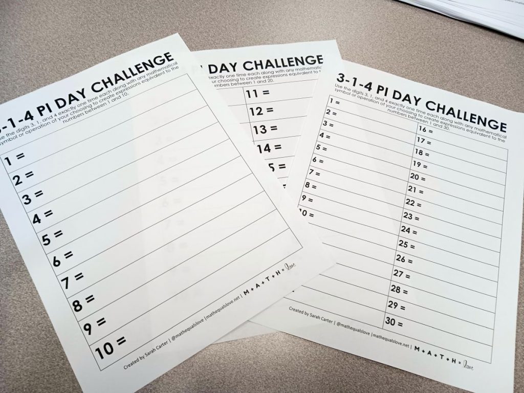 three copies of 3-1-4 pi day number challenge lying on desk 