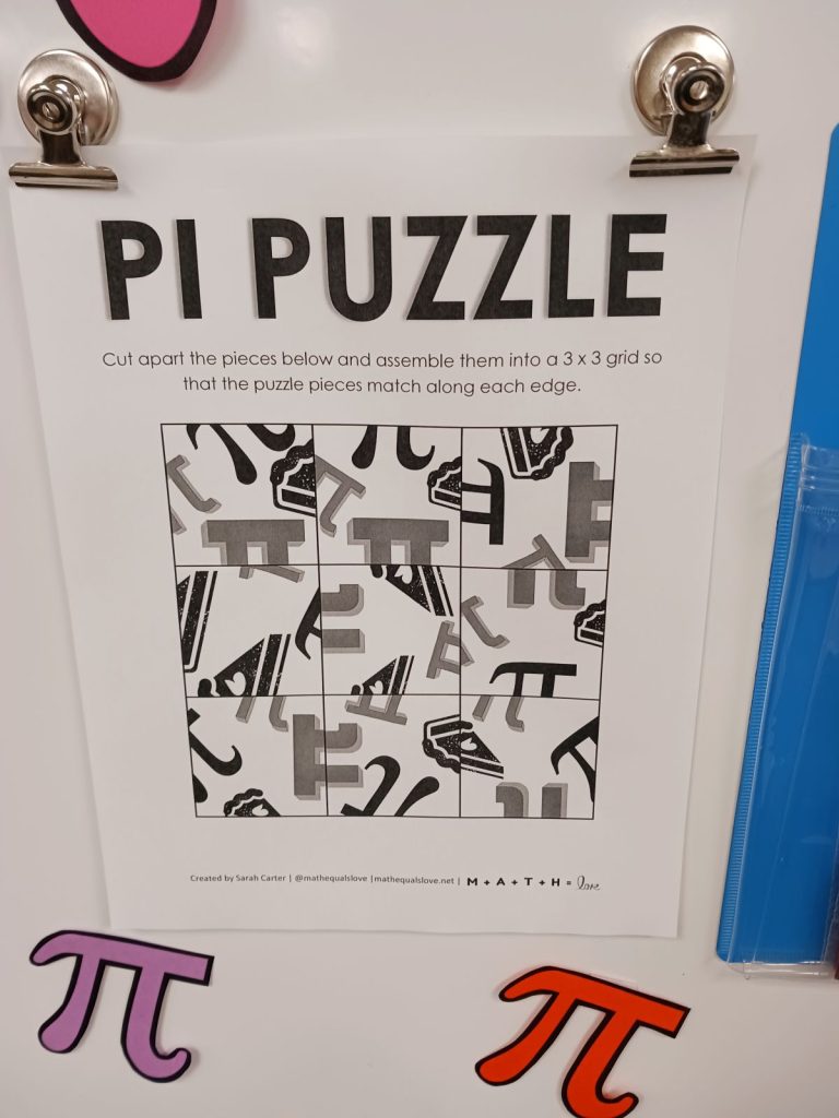 pi puzzle for pi day hanging on dry erase board from magnetic clips 