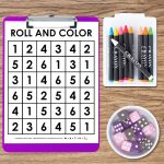 roll and color worksheet on purple clipart with bowl of dice and tray of crayons