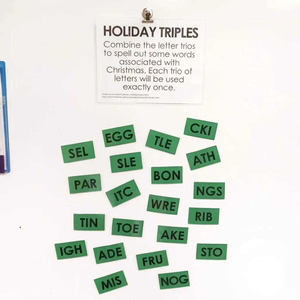 holiday triples word puzzle hanging on dry erase board in classroom 