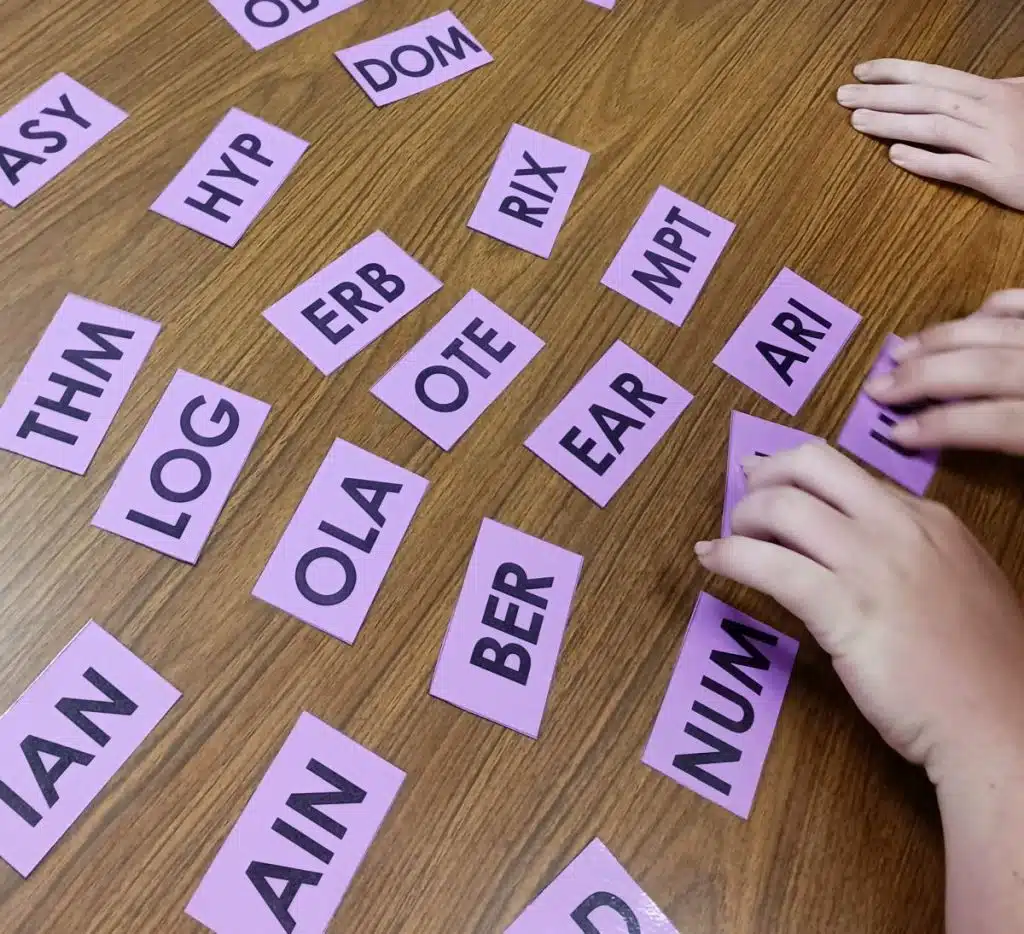 student hands working to solve math triples puzzle 