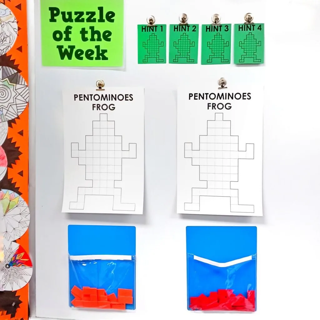 pentominoes frog puzzles hanging on dry erase board in math classroom 