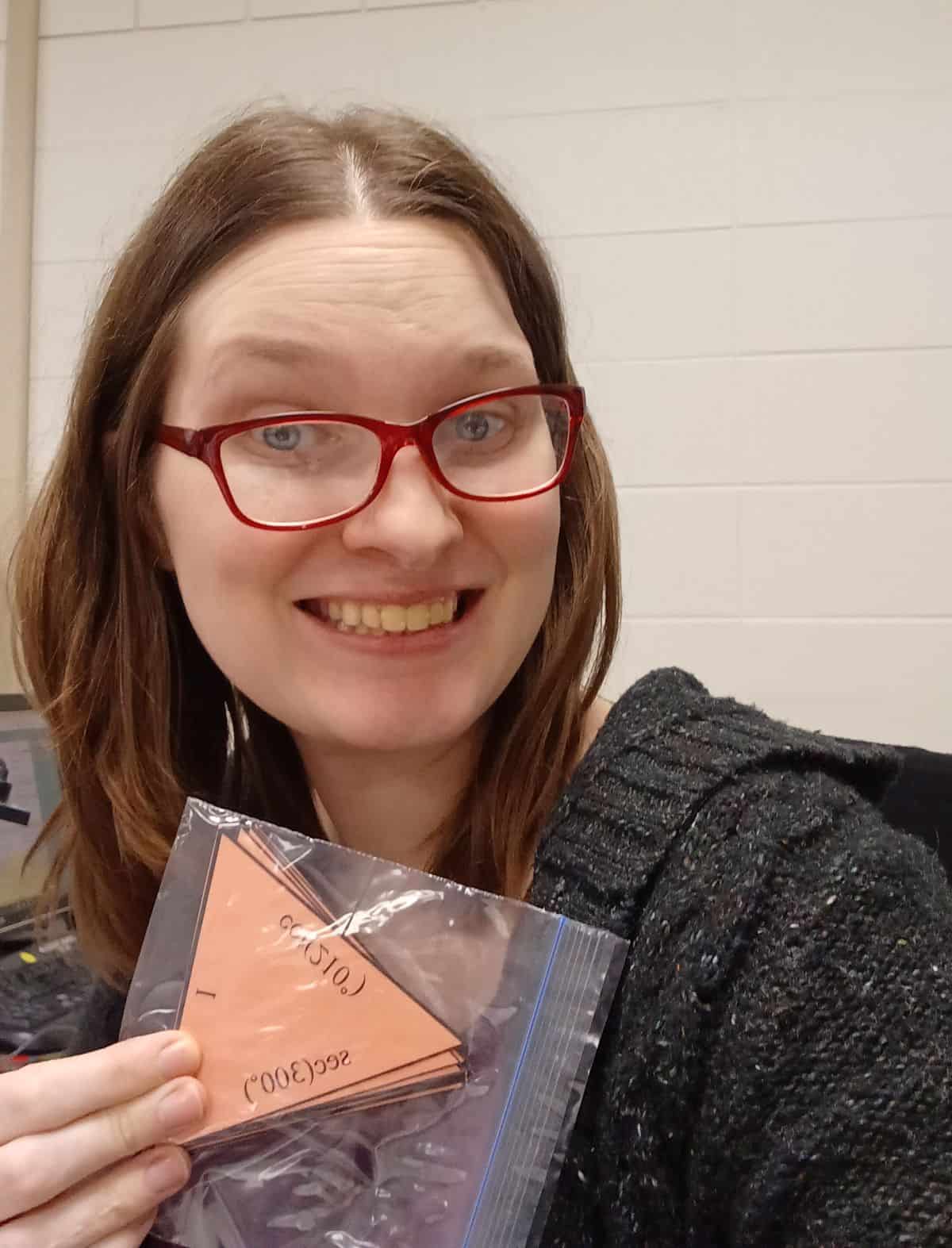 Sarah Carter (mathequalslove) holding ziplock bag full of tarsia triangle puzzle pieces for evaluating trig functions activity 