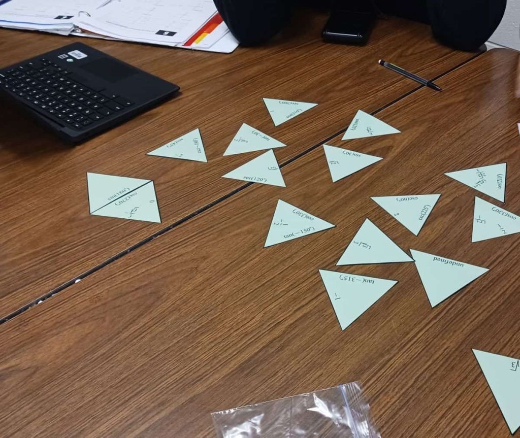 partially attempted solution on student table of evaluating trig functions tarsia puzzle activity 
