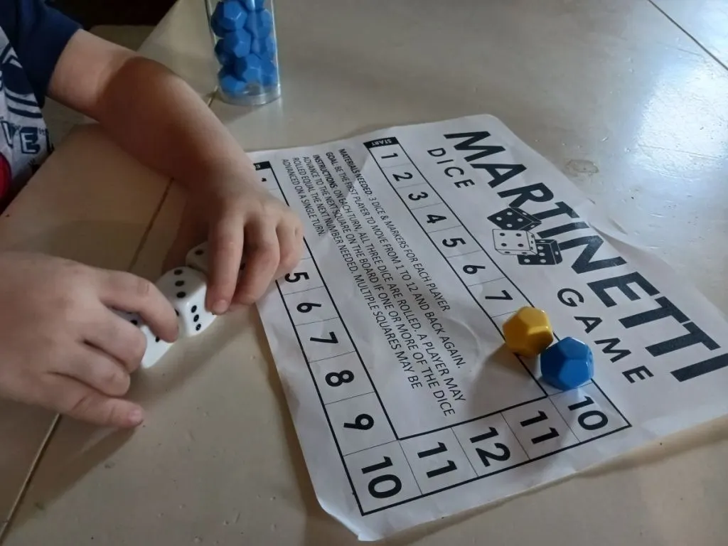 four year old playing martinetti dice game 