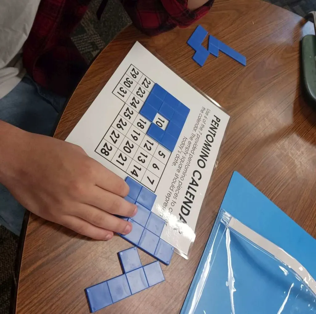 student working on pentomino calendar puzzle 