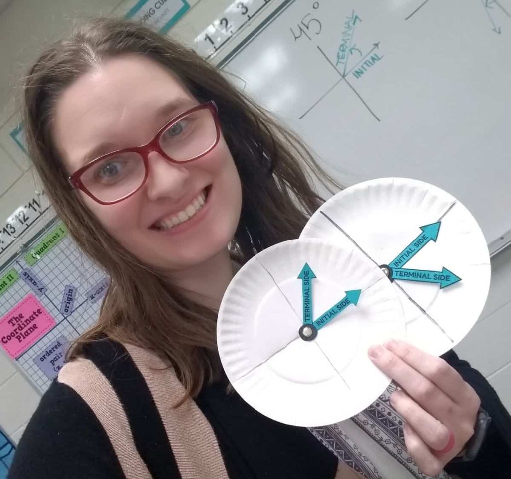 sarah carter holding paper plate angle spinners in high school trigonometry class 