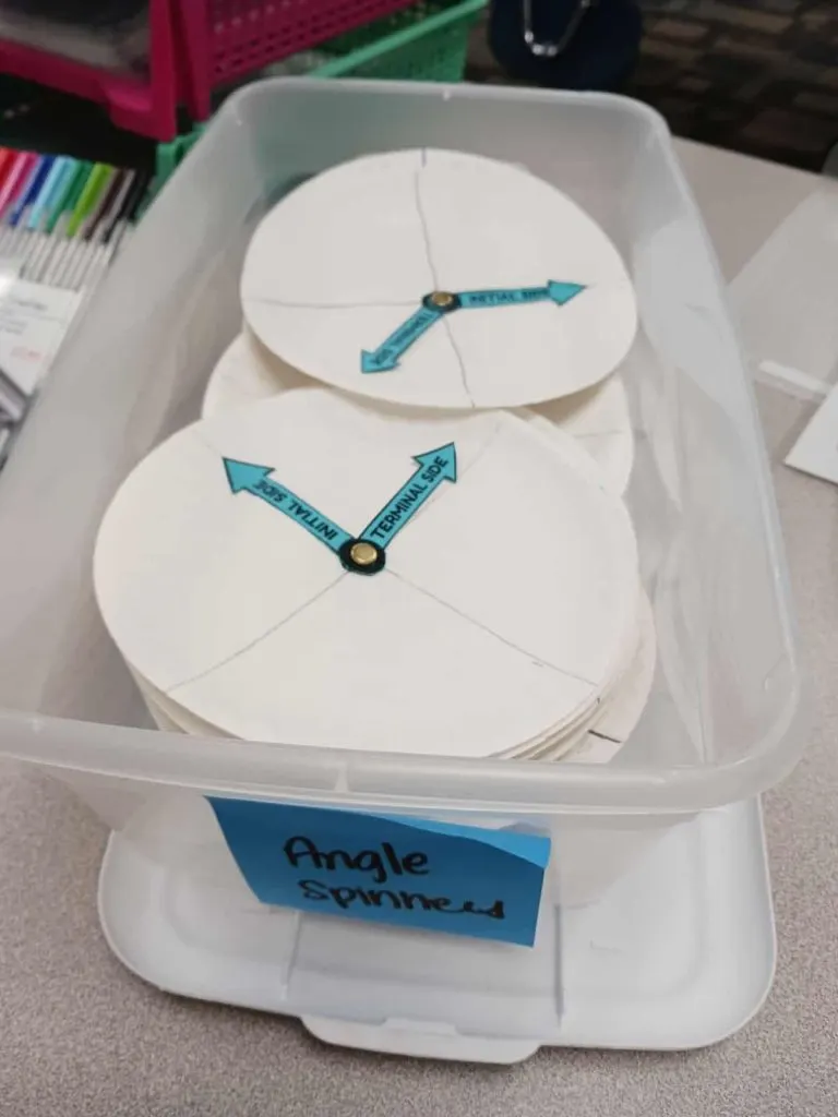 paper plate angle spinners in clear plastic box in math classroom 