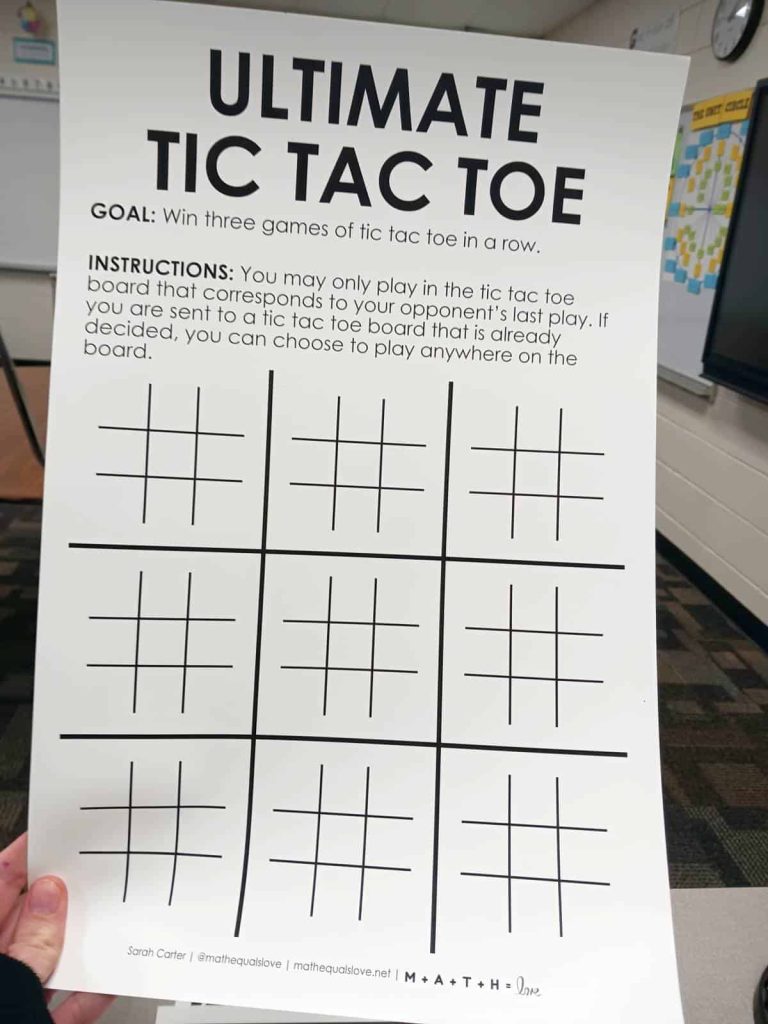 ultimate tic tac toe game template being held up in high school math classroom 