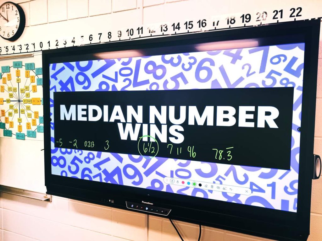 "median number wins" displayed on promethean board in high school math classroom 