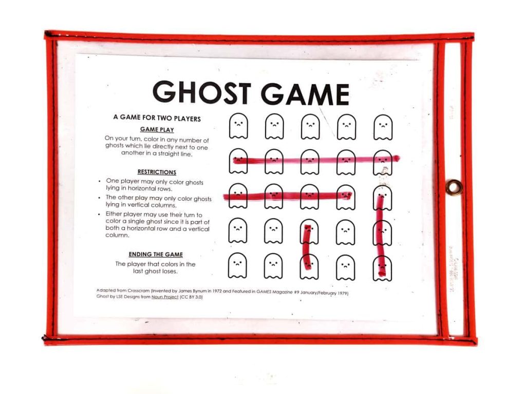 example of ghost game being played with dry erase markers on top of dry erase pocket. 