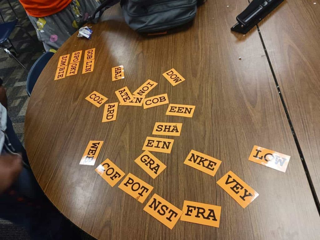 students working on solving halloween triples word puzzle in high school math classroom 