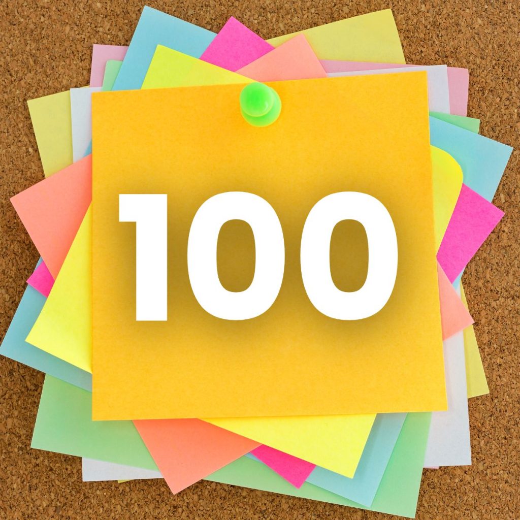 number 100 on top of a stack of post-it notes. 