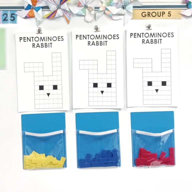 pentominoes rabbit puzzles hanging on dry erase board.