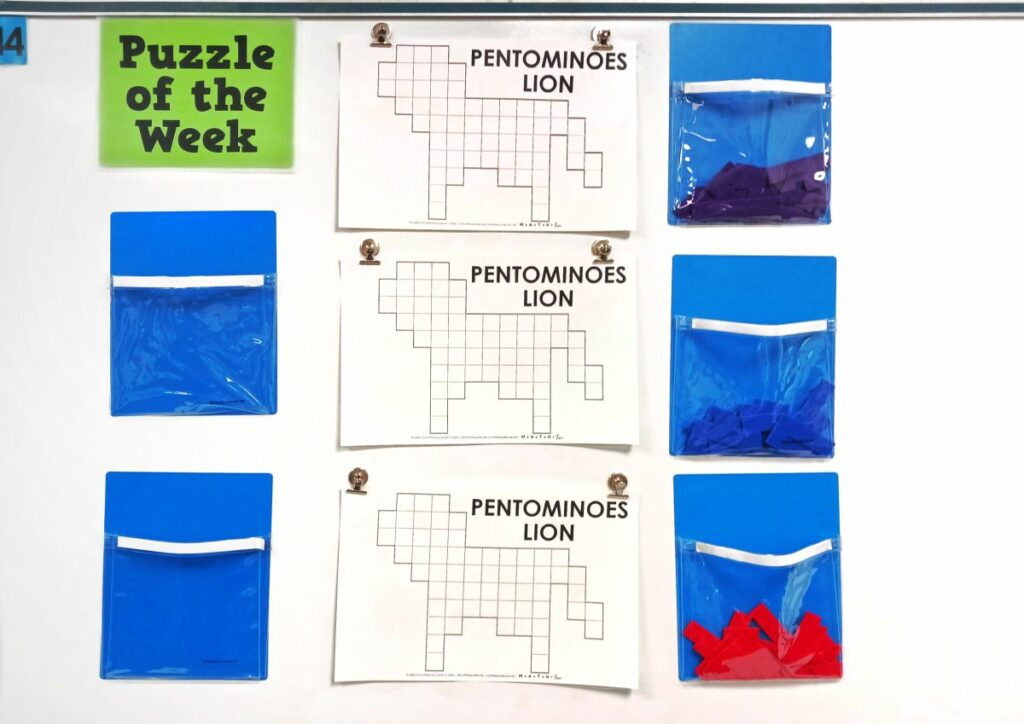 pentominoes lion puzzle hanging on dry erase board in classroom. 