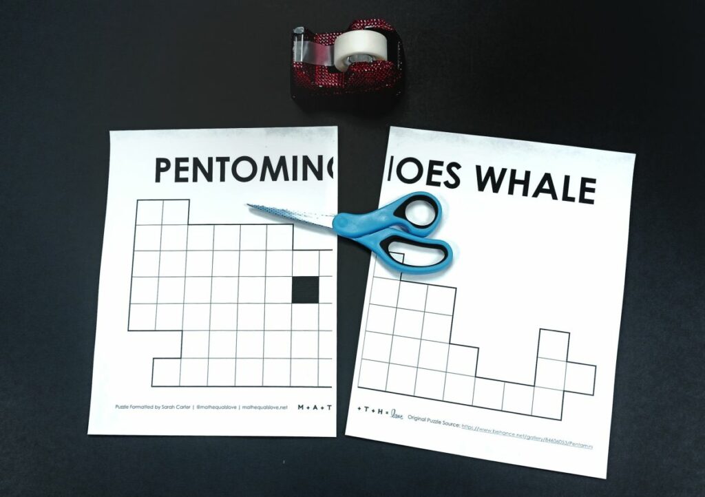 letter sized version of pentominoes whale puzzle with scissors and tape laying on top. 