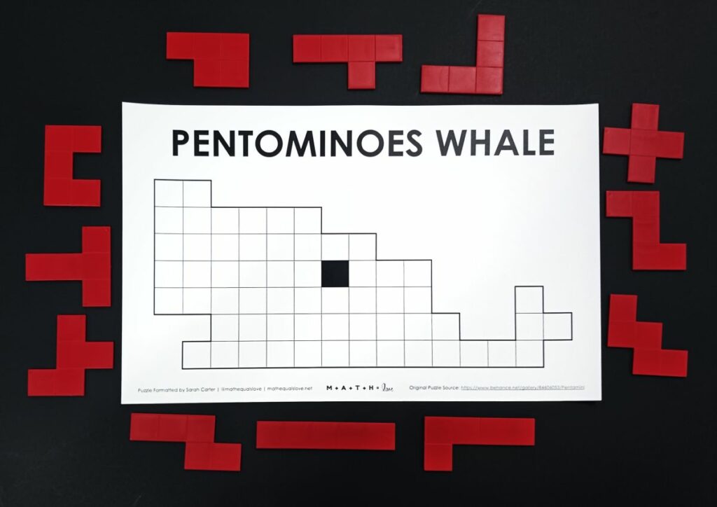 pentominoes whale puzzle with pentomino pieces around outside of puzzle. 