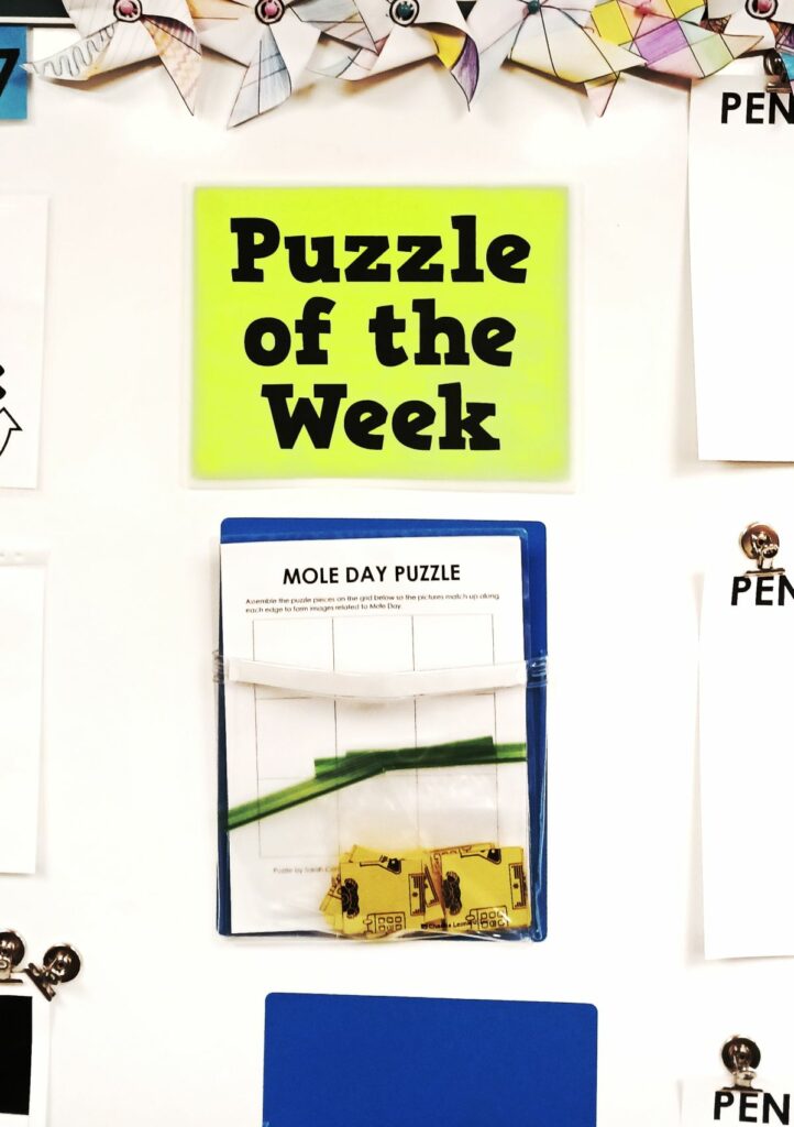 mole day puzzle in dry erase pocket under sign reading "Puzzle of the week" 