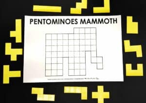 pentominoes mammoth puzzle with pentomino pieces surrounding it.