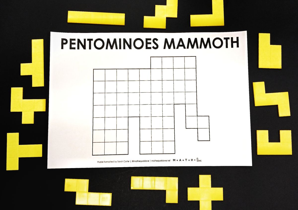 pentominoes mammoth puzzle with pentomino pieces surrounding it.