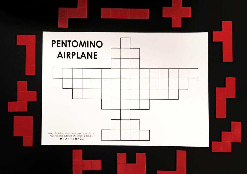 pentomino airplane puzzle with pentominoes surrounding the puzzle. 