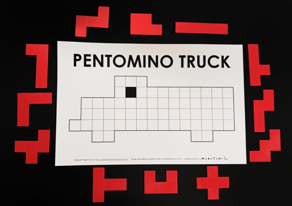 pentomino truck puzzle with pentominoes pieces scattered around. 