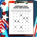 Veterans Day Dots and Boxes Game on clipboard next to patriotic decorations.