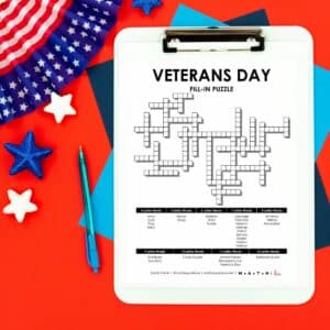 Veterans Day Fill-In word puzzle on clipboard next to patriotic decorations.