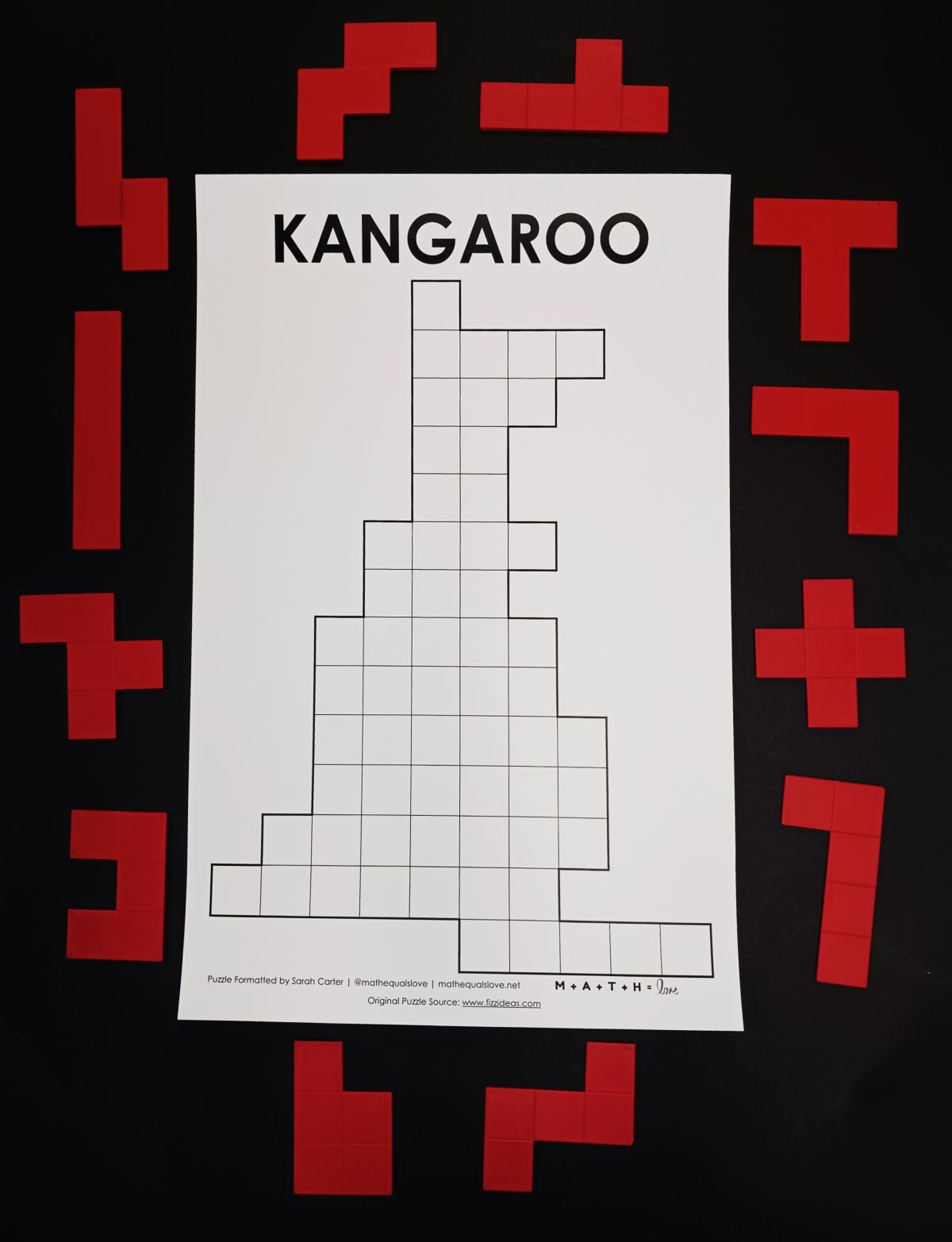 pentominoes kangaroo puzzle surrounded by red pentomino pieces.